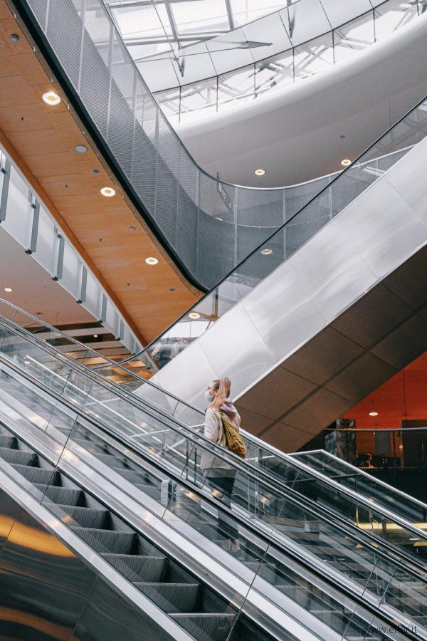woman-standing-on-escalator-3943879