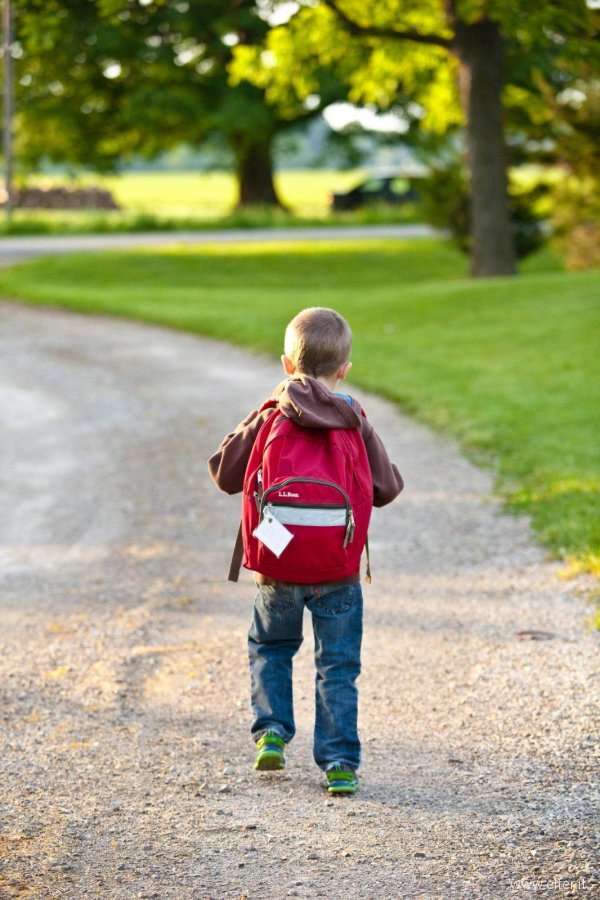 boy-in-brown-hoodie-carrying-red-backpack-while-walking-on-207697